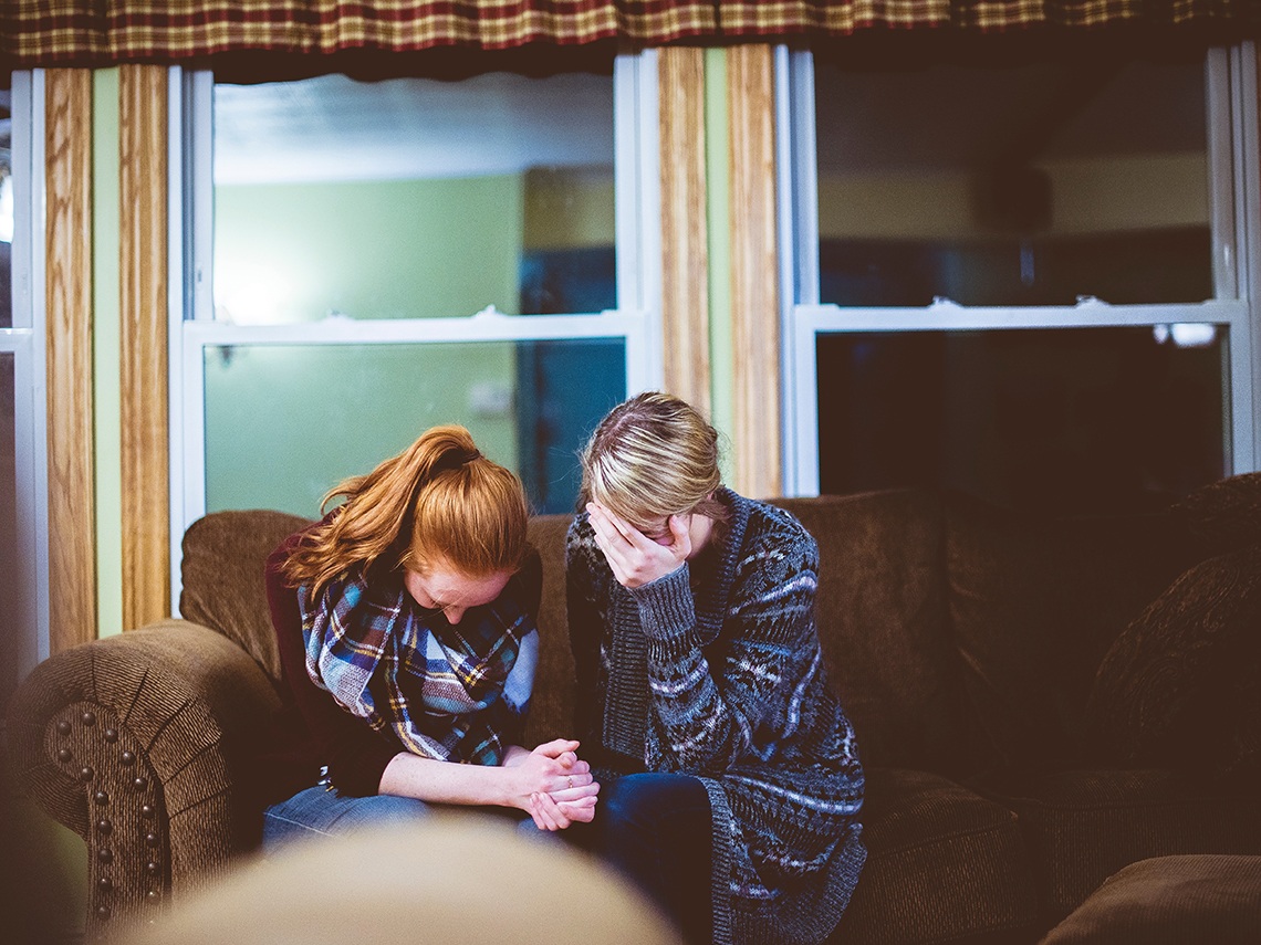 Woman praying for girl